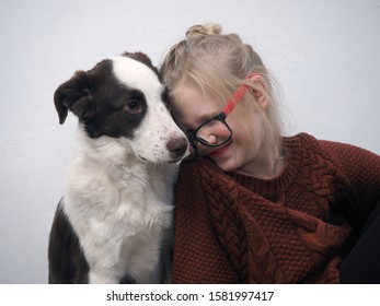 Emotional Portrait Of A Girl And A Dog. The Child Has Poor Eyesight, Glasses