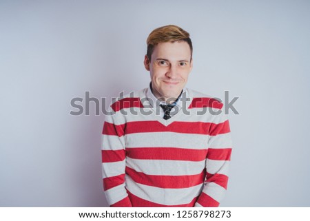 Emotional portrait of a guy,  business style in clothes: shirt and jeans. emotional portrait. short hair and clean skin. Young brutal man with short hair, emotional portrait.
