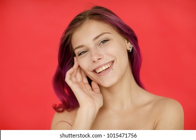 Emotional Portrait Of A Happy And Positive Beautiful Nude Young Woman With Bright Hair Looking With A Smile And A Window, Pressing Her Hand To Her Face Against The Red Wall. European Woman
LIFESTYLE
