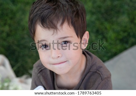 Similar – Image, Stock Photo Brown-haired boy with an athletic physique on an athletic oval massages his muscles with a foam roller for better recovery. Post-workout