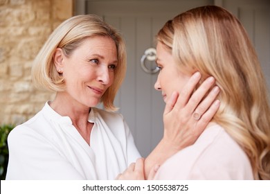 Emotional Senior Mother Saying Goodbye To Adult Daughter As She Leaves Home For University