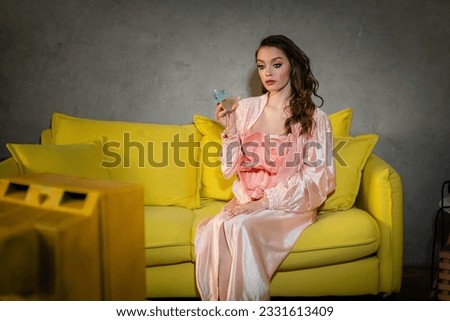 emotional stress, sad woman with smudged mascara sitting on yellow couch, housewife with crying eyes watching tv, holding glass with cocktail, feeling lonely and depressed, heartbroken wife