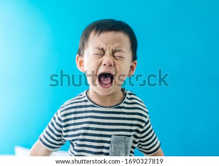 Emotional Tantrum and Angry little boy at home.Stay at home self quarantine at home from covid-19 coronavirus.Depressed toddler complaining.Attention deficit hyperactivity disorder (ADHD) Concept.
