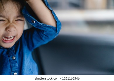 Emotional Tantrum And Angry Little Girl In The Car.Mad Kid Got Upset And Sad And She Has A Negative Attitude.Depressed Little Girl Complaining.Attention Deficit Hyperactivity Disorder (ADHD) Concept.