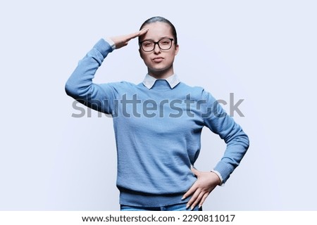 Emotional teenage girl posing on white studio background