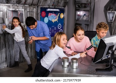 Emotional Tween Children Using Computer Trying To Solve Riddles In Quest Room As Underground Shelter. Generation Alpha And Questomania Concept..