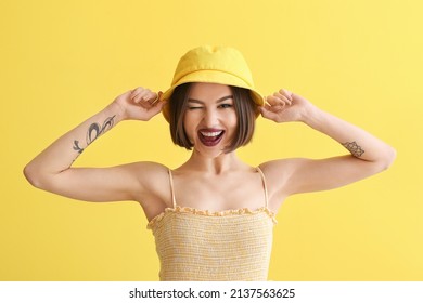 Emotional Woman With Dark Lipstick In Bucket Hat On Color Background