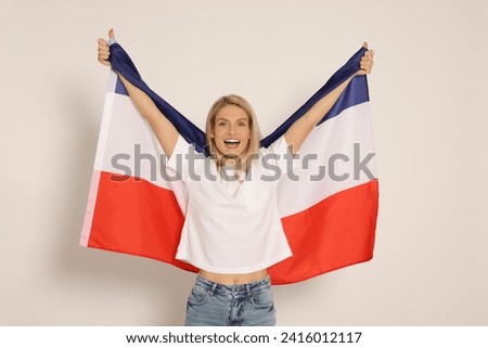 Emotional woman with flag of Netherlands on white background