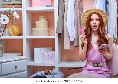 Emotional Woman At Home Holding Credit Card, Going To Make Purchase, Shopaholic In Pink Dress. Make Purchases With Credit Card During Self-isolation. Modern Virtual Shopping. Independent Stylist