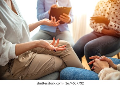 Emotional woman sharing her story during support session for addicts, close up on gesticulating hands. Close-up of therapist's hands explaining a problem to his patients - Powered by Shutterstock