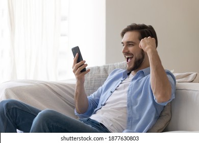 Emotional young caucasian man looking at cellphone screen, celebrating winning mobile game or getting price in online lottery, reading message with unbelievable pleasant news, good luck concept.