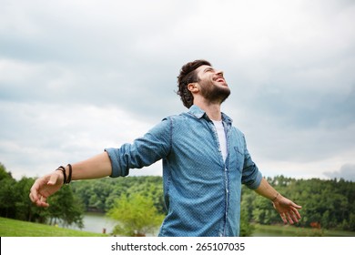 Emotional Young Man Laughing In Wind