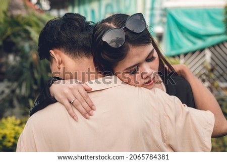 An emotional young woman hugs her boyfriend. Looking for comfort after a bad day at work, or loss of loved one.