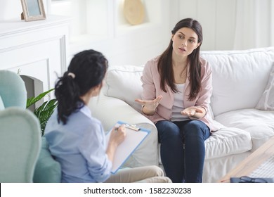 Emotional Young Woman Sharing Her Feelings With Psychotherapist At Regular Session, Copy Space