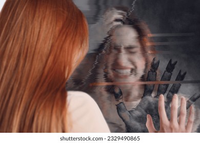 Emotional young woman suffering from hallucinations. Hand touching broken mirror on backside, glitch effect