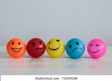 Emotions balls background, Happy Smiley faces ball in yellow , orange and pink. Sadness ball in blue and madness ball in red. Self made hand draw balls. - Shutterstock ID 715595248