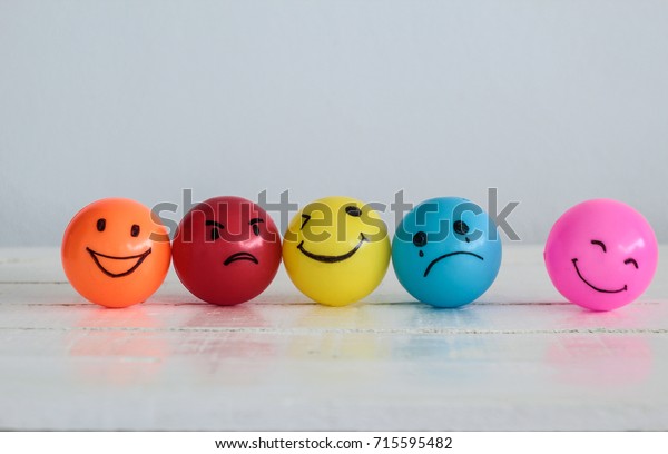 Emotions balls background, Happy Smiley faces\
ball in yellow , orange and pink. Sadness ball in blue and madness\
ball in red. Self made hand draw\
balls.