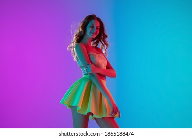 Emotions. Beautiful seductive girl in fashionable yellow skirt on gradient pink-blue neon background. Half-length portrait. Copyspace for ad. Flyer design. Summer, fashion, human emotions concept. - Shutterstock ID 1865188474