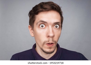 Emotions concept. Portrait of shocked male with small beard says wow, looks bugged eyes and rounded mouth, being amazed to see something unexpected. Terrified guy with surprised expression.
