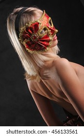emotions on the face of the girl in the Venetian mask on black background - Shutterstock ID 456133561