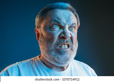 Emotions of a television fan. Screaming, hate, rage. Crying emotional angry man screaming in colorful bright lights at studio. Emotional, mature face. Human, facial expression concept. - Shutterstock ID 1070714912