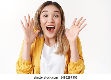 Emotive excited screaming asian blond girl yell about amazing shocking surprising great news shaking hands astonished smiling joyful delighted open mouth gasping incredible excellent opportunity