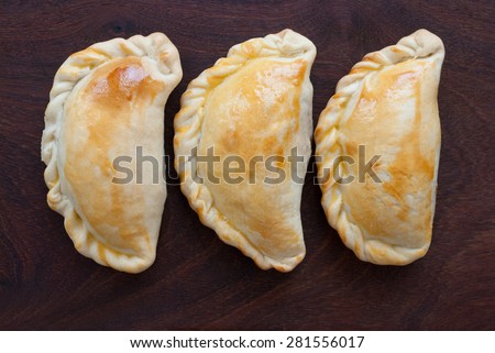 empanada - southamerican traditional food  on wooden background