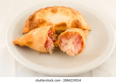 
Empanada Stuffed With Ham And Cheese Cut In Half Hot