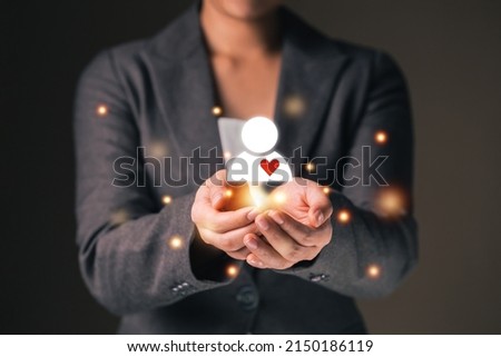 Empathy female manager holding human icon with heart shape over palm hands. Power of emotional intelligent, soft skill development concept.