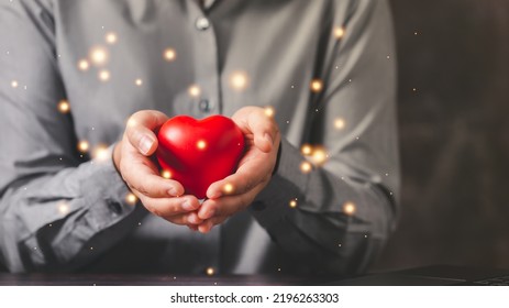 Empathy female manager holding red heart shape ball over palm hands. Power of emotional intelligent, soft skill development concept. Mental health - Shutterstock ID 2196263303