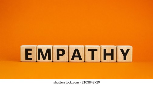 Empathy symbol. The concept word Empathy on wooden cubes. Beautiful orange table, orange background, copy space. Business, psychological and empathy concept.