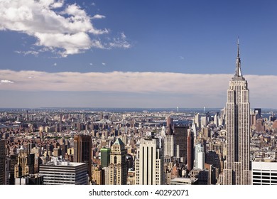 The Empire State Building rises above the Chelsea and the Garment District, Lower Midtown all the way to Lower Manhatten of New York City.