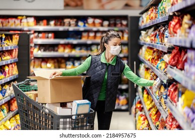 An Employee Arranges Groceries On Shelves In Supermarket During Covid 19.