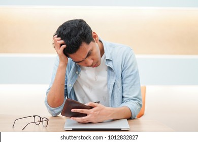 Employee Asian Man Check Blank Wallet With Stress And Confuse Emotion After Pay Debt (credit Card Monthly Expense) And Mortgage Home Loan In The End Of Month For Financial Risk And Lifestyle Concept