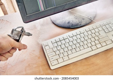 Employee Cleans A Dusty Keyboard And Dusty Desk With Air Duster Cleaning Spray Gun In The Workshop Closeup