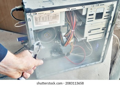 Employee Cleans An Open Old Computer With Air Duster Cleaning Spray Gun In The Workshop Closeup