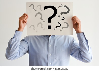 Employee dilemma with question marks on blank paper - Shutterstock ID 313506980