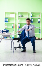 Employee Doing Exercises During Break At Work