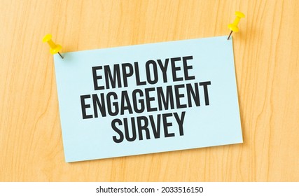 Employee Engagement Survey sign written on sticky note pinned on wooden wall - Shutterstock ID 2033516150