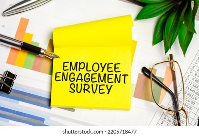 EMPLOYEE ENGAGEMENT SURVEY Text On The Yellow Paper With Pen And Glasses