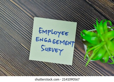 Employee Engagement Survey Write On Sticky Notes Isolated On Wooden Table. Selective Focus On Employee Engagement Text