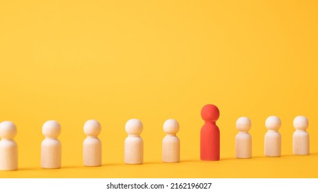 An Employee Figurine Comes Out Of A Row Of Colleagues. Promotion At Work, Appointment To The Role Of Team Leader. Dismissal Of An Employee. Take The First Step, Be Different. Initiative And Aspiration