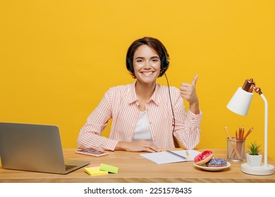 Employee fun operator business woman in set microphone headset for helpline assistance wear shirt sit work at call center office desk with pc computer show thumb up isolated on plain yellow background - Powered by Shutterstock