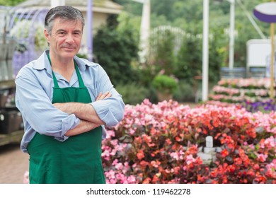 Employee In The Greenhouse In Garden Center