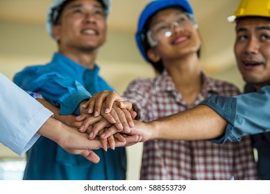 Employee Group From Asian Factory Make Hand Shake. Manager And Worker Meeting To Good Factory Performance. The Worker Is Importance For Factory.the Factory Unshaken Because Employee Have Good Relation