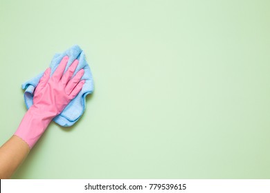 Employee Hand In Rubber Protective Glove With Micro Fiber Cloth Wiping Wall From Dust. Maid Or Housewife Cares About House. Spring General Or Regular Clean Up. Commercial Cleaning Company Concept.