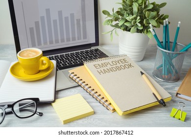 Employee Handbook On Office Table With Computer Laptop. Business Concept For Design 