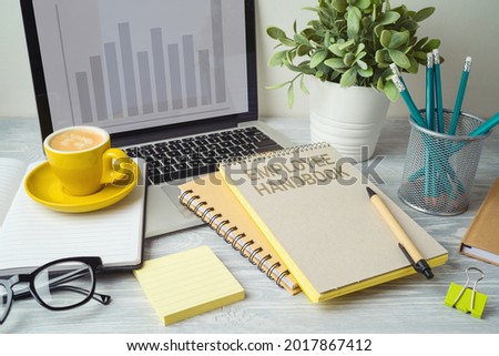 Employee handbook on office table with computer laptop. Business concept for design 