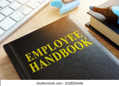 Employee Handbook On A Wooden Desk.