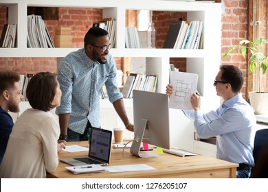 Employee Holding Blueprint Speaking Presenting New Architecture Design Project Plan At Diverse Architects Team Meeting, Multi-ethnic Workers Designers Group Listen To Creative Idea At Office Briefing